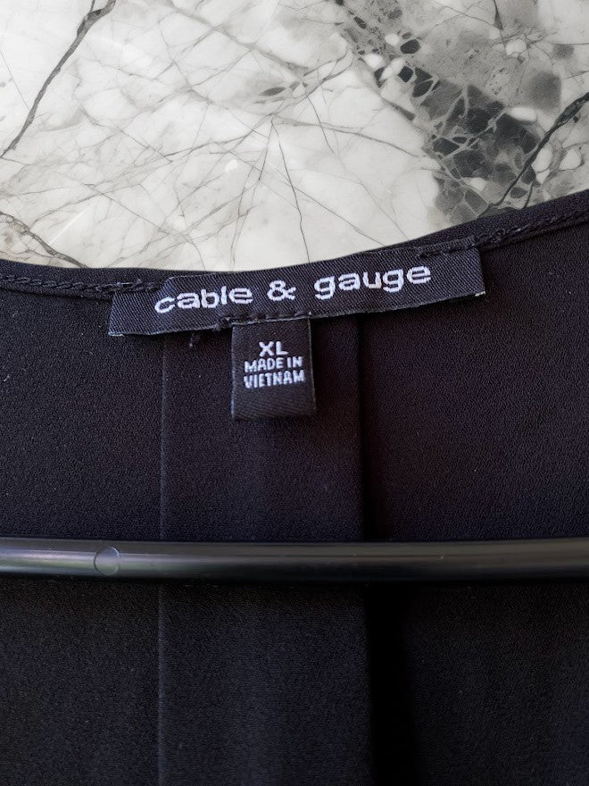 Enhance your professional wardrobe with the Cable & Gauge Black Sleeveless Blouse