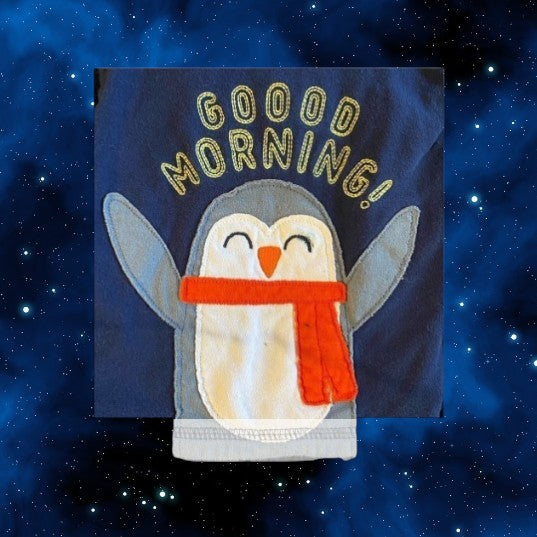 The Carter's Just One You penguin appliqué pajama top, features a playful blue multicolor design