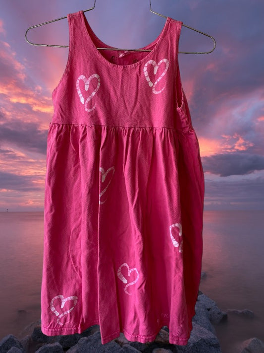 Pretty and flowy girl's pink sleeveless dress with heart pattern designs