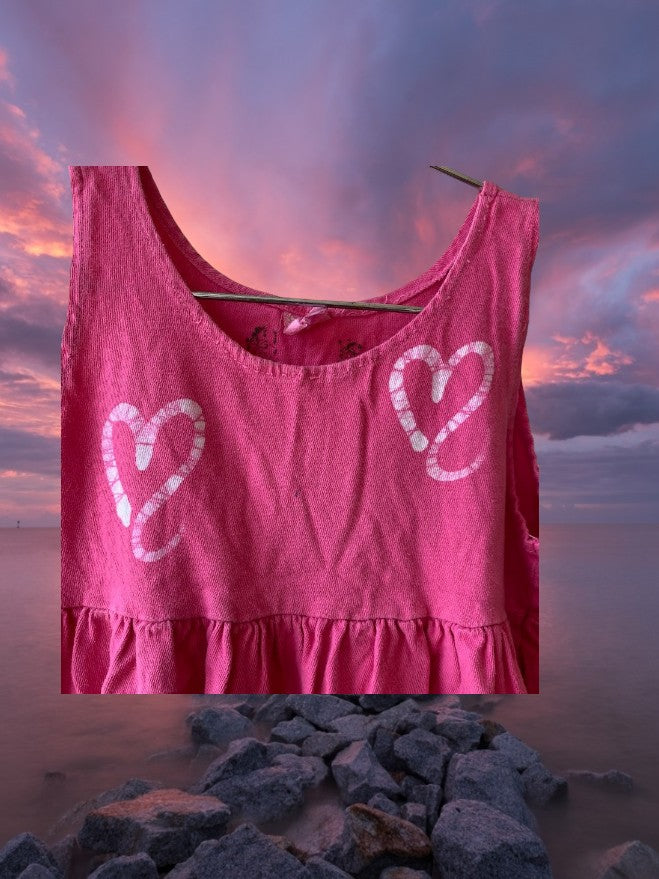 Pretty and flowy girl's pink sleeveless dress with heart pattern designs