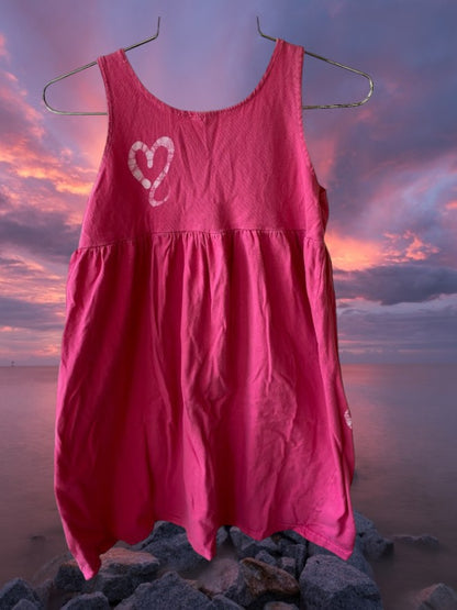 Pretty and flowy girl's pink sleeveless dress with heart pattern designs