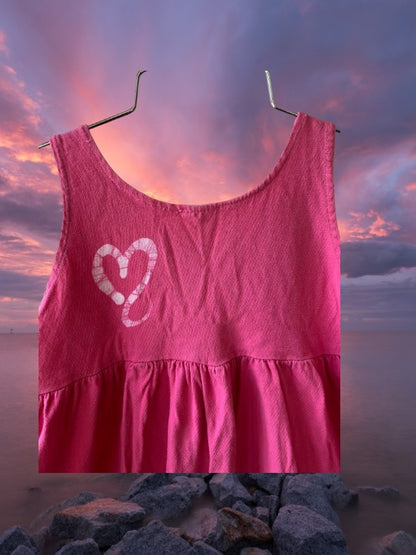 Pretty and flowy girl's pink sleeveless dress with heart pattern designs