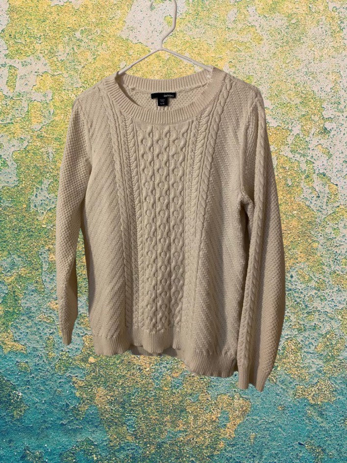 Cable Knit Sweater design features a hi-low hem adding a touch of style and structure