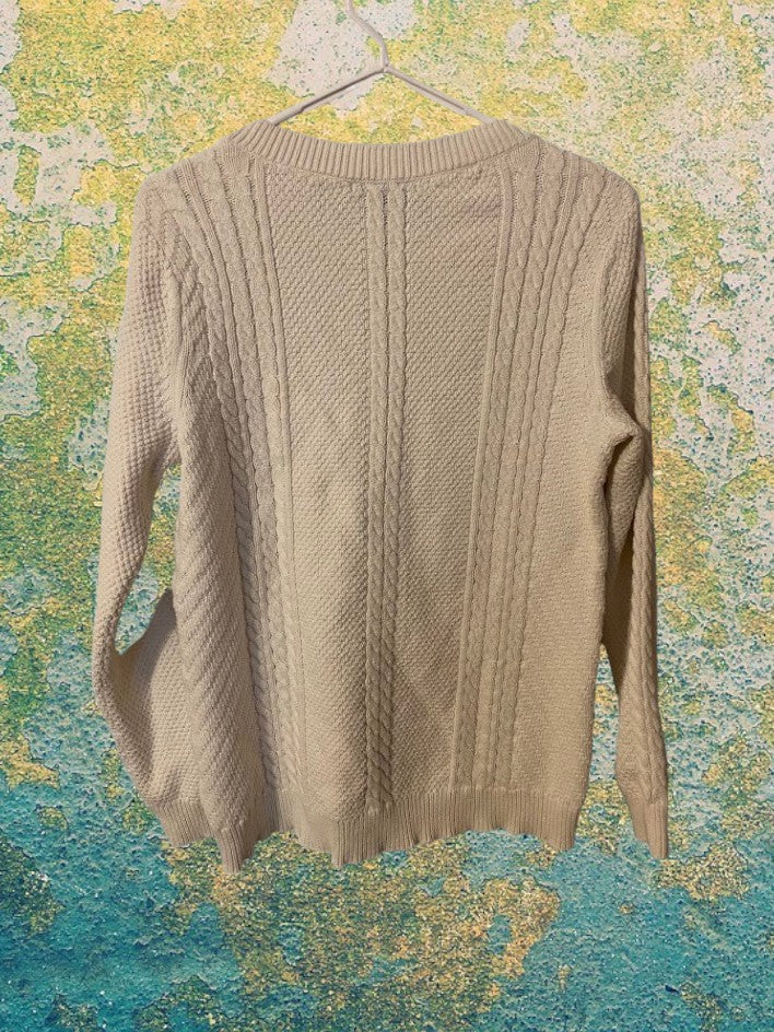 Cable Knit Sweater design features a hi-low hem adding a touch of style and structure